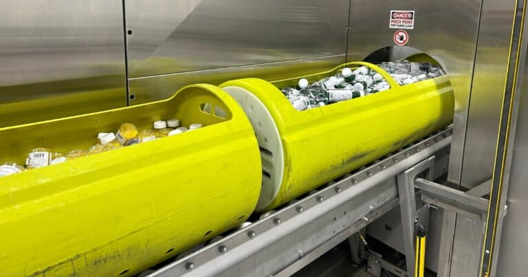 Drink bottles in an HPP vessel on a production line.